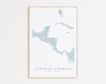 May include: A printable map of Central America in a light blue color with a white background. The map is framed in a light wood frame. The text "Central America 12.7480° N, 85.6034° W" is printed below the map.