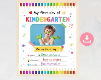 May include: A printable sign for the first day of kindergarten featuring a colorful border of pencils, a central photo frame, and text fields for a child to fill in their feelings, what they learned, and what they made during their first school day.