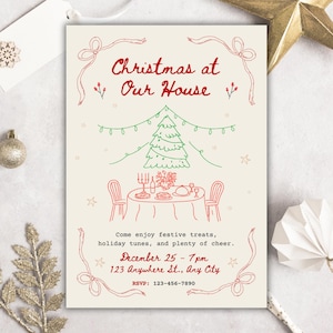 May include: Cream-colored Christmas invitation with red and green hand-drawn illustrations. The text reads "Christmas at Our House" above a Christmas tree and a table setting. Includes event details: December 25, 7 pm, and RSVP information.