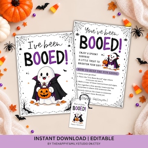 May include: Two rectangular white cards and one small rectangular tag featuring the text "I've been BOOED!" and "You've been BOOED!" with a cartoon ghost wearing a vampire cape and holding a jack-o'-lantern, surrounded by spider web borders.