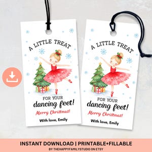 May include: Two white gift tags with black string, featuring a watercolor illustration of a ballerina in a red dress, a Christmas tree, and the text "A LITTLE TREAT" and "FOR YOUR dancing feet! Merry Christmas!"
