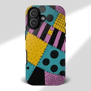 May include: A colorful phone case featuring a patchwork design with yellow, teal, purple, and black sections. The case has a glossy finish and a camera cutout. The design includes polka dots, stripes, and stitched details.