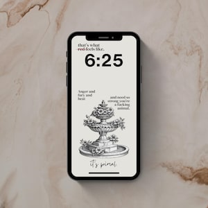 以下が含まれることがあります： 黒いスマートフォンには、噴水のイラストとテキストの壁紙が表示されています。時刻6:25が大きく表示されています。テキストには「that's what red-feels like」、「Anger and fury and heat」、および「it's primal」が含まれています。