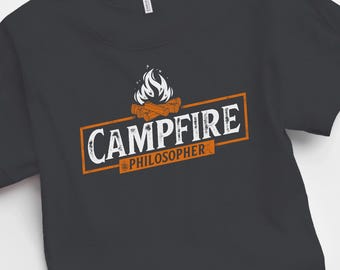 May include: A black t-shirt with a white graphic of a campfire with the text "Campfire Philosopher" in a white rectangle.