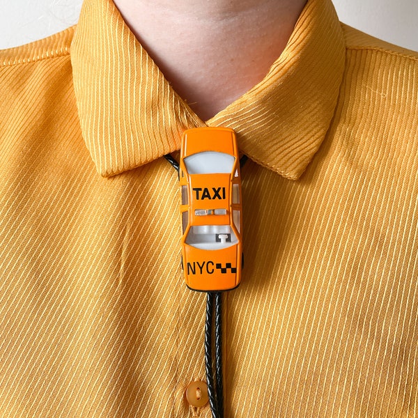 Bolo neck tie NYC TAXI, handmade, NYC taxi orange metal and plastic toy car, black braided leather cord and silver end tips