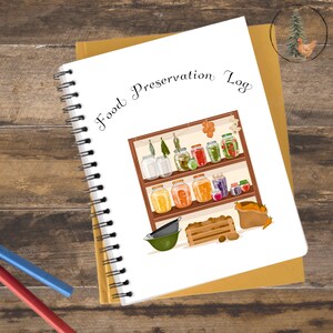 May include: A spiral-bound notebook with the words "Food Preservation Log" on the cover. The cover illustration depicts a shelf filled with jars of preserved food, vegetables, and a sack of carrots. The notebook rests on a wooden surface.