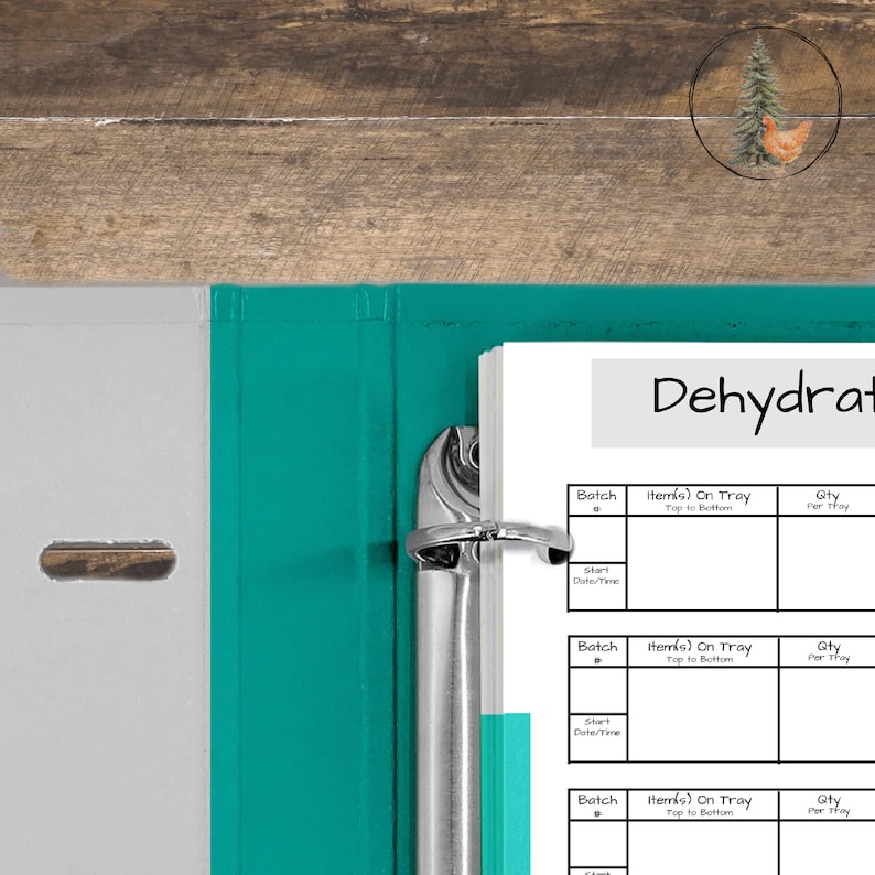 May include: A teal and white binder with a metal ring mechanism, holding a stack of white paper. The paper has a title that says "Dehydrat" and has a table with columns for batch, items on tray, and quantity.