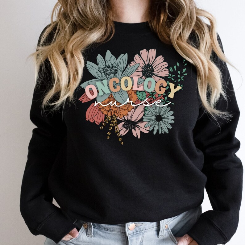 May include: Black sweatshirt with a floral design and the text "ONCOLOGY nurse" in colorful letters.