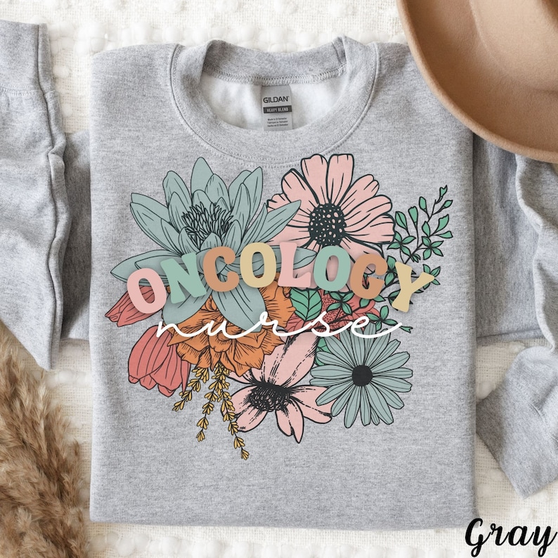 May include: Gray sweatshirt with a floral design and the text "ONCOLOGY NURSE" in colorful letters.