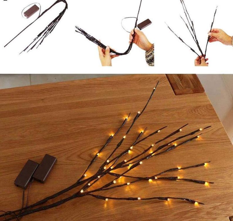 May include: A set of brown twig branches with warm white LED lights. The branches are arranged in a vase or on a table. The lights are on and create a warm glow.