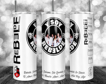 May include: A white tumbler with a black and white graphic of a band called "Rebelde" with the text "Y Soy Rebelde". The tumbler has a black lid and a black straw. The tumbler also has a black and white graphic of a crown with the letters "RBD" inside. The tumbler has a measurement of 20 fl oz.