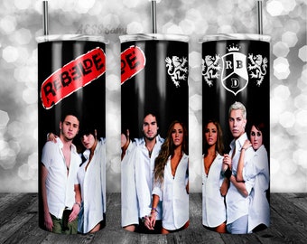 May include: A black tumbler featuring images of a musical group. The tumbler has a red banner with the word "REBELDE" and a logo with the letters "RB" and a crown. The group members are wearing white shirts.