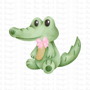 May include: A green alligator with a pink bow holding a light brown stick. The alligator is sitting on a white background.