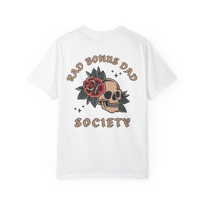 May include: White t-shirt with a skull and rose graphic and the text "Rad Bonus Dad Society" printed on the back.