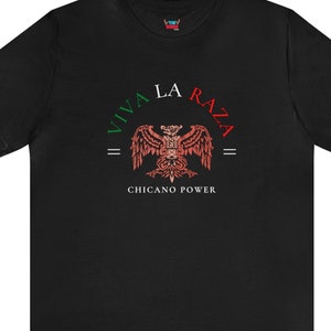 May include: Black t-shirt with a red, white, and green graphic of an eagle with the text "Viva La Raza = Chicano Power =" printed on the front.