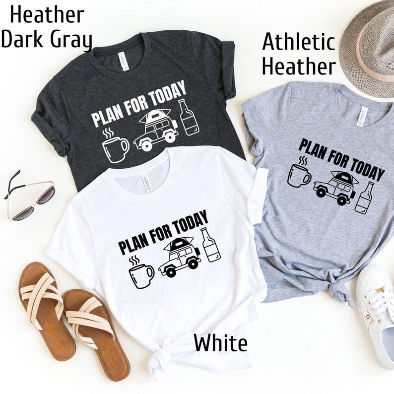 May include: Three t-shirts in different colors: dark gray, white, and athletic heather. Each shirt features a black and white graphic of a car with a tent on top, a coffee cup, and a beer bottle. The text "PLAN FOR TODAY" is printed on each shirt.