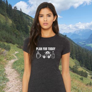 K&ouml;nnte beinhalten: Ein dunkelgraues T-Shirt mit einem wei&szlig;en Grafikdesign. Die Grafik zeigt eine Tasse Kaffee, ein Auto mit einem Zelt auf dem Dach und eine Flasche Bier. Der Text "PLAN FOR TODAY" befindet sich &uuml;ber der Grafik.
