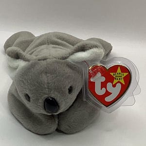 May include: Gray plush koala beanie baby toy with a white Ty heart tag that says "Beanie Original Baby".