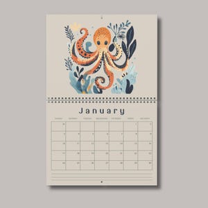 May include: A wall calendar for the month of January featuring a central illustration of an orange octopus surrounded by dark blue and light blue seaweed and coral elements. The calendar grid displays the days of the week and numerical dates.
