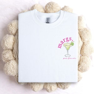 May include: White crew neck sweatshirt with a pink graphic of a margarita glass and the text "margs. por favor".