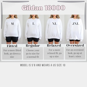 May include: A size chart for Gildan 18000 sweatshirts, showing four different sizes: M, L, XL, and 2XL. The chart shows a model wearing each size and provides a description of the fit for each size. The model is wearing a white sweatshirt and black shorts. The text on the chart reads: "Fitted", "Regular", "Relaxed", and "Oversized". The chart also includes a description of each fit. The model is 5'8 and wears a US size 10.