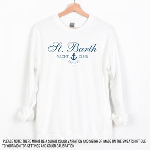 May include: White sweatshirt with a navy blue logo that says "St. Barth Yacht Club Est. 1648" with an anchor symbol.