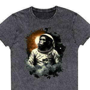 Space Monkey Astronaut tshirt featuring a monkey astronaut sitting alone in space, thought-provoking, philosophical, graphic t shirt