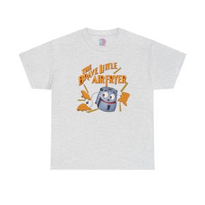 May include: A gray t-shirt with a cartoon air fryer with a smiling face and the text "The Brave Little Air Fryer" in orange.