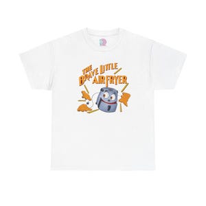 May include: White t-shirt with a cartoon air fryer with a face and the text "The Brave Little Air Fryer" in orange.