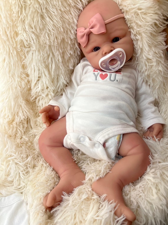 Full body silicone baby, wears newborn clothes
