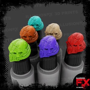 May include: A set of six miniature sci-fi helmet heads in bright colours including lime green, orange, teal, beige, purple, and red. Each helmet features a textured, stitched surface pattern and integrated breathing apparatus details on the lower face.