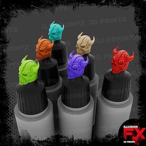 May include: Six paint dropper bottles with black caps, each topped with a 3D printed skull helmet topper in lime green, orange, teal, tan, purple, and red. The bottles are labelled with the text ILLUSIONFX 3D PRINTS in the background.