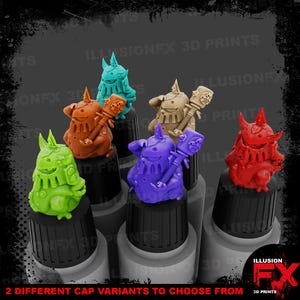 May include: A collection of six small, colourful fantasy creature figurines, each perched atop a black bottle cap. The figures are rendered in bright green, orange, teal, tan, purple, and red, featuring horned heads and holding staff-like accessories.