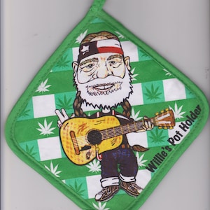May include: Green and white checkered pot holder with a cartoon of a man playing a guitar. The pot holder has a green border and a wooden ring for hanging. The text "Willie's Pot Holder" is printed on the side.