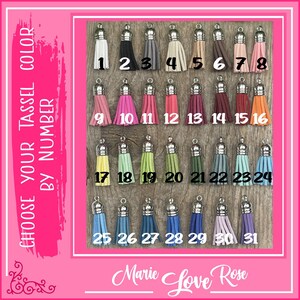 May include: Thirty-one different colored tassels with silver tops. The tassels are arranged in rows of 8, 7, and 8. Each tassel is numbered from 1 to 31.