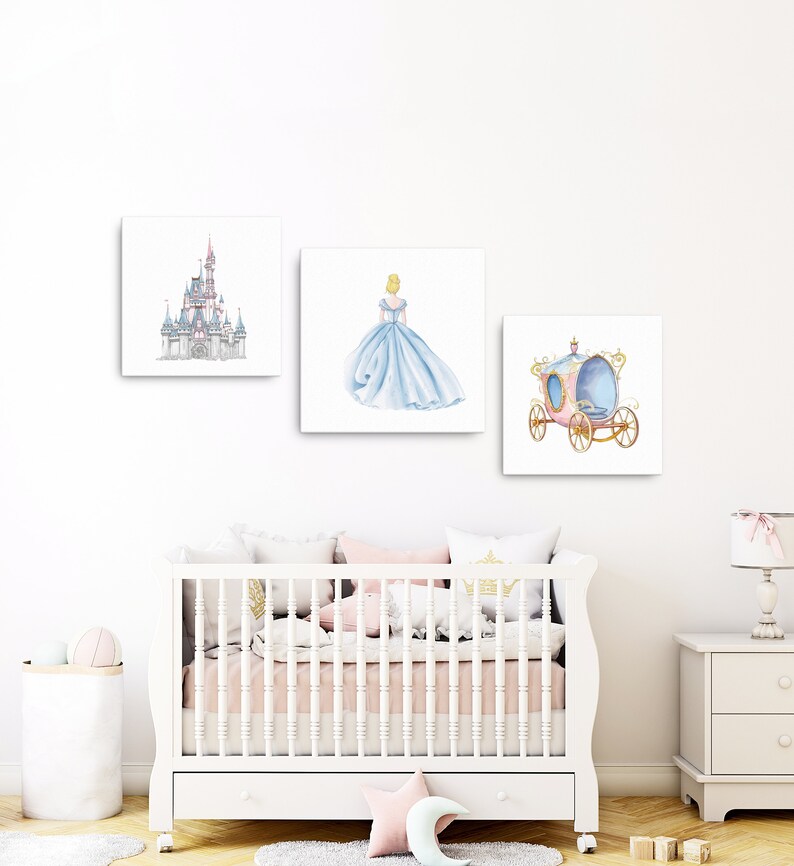 May include: Three watercolor prints featuring Cinderella themed imagery. The first print shows Cinderella's castle, the second print shows Cinderella in her blue ball gown, and the third print shows Cinderella's carriage.