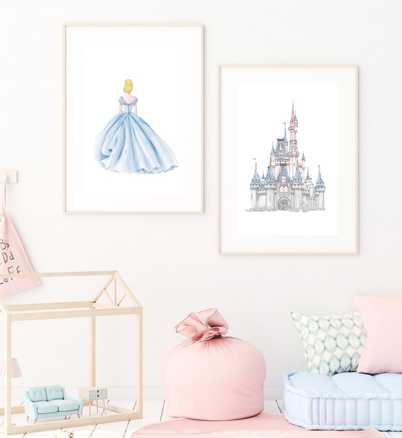 May include: Two framed prints, one with a watercolor illustration of Cinderella in her blue ball gown, the other with a watercolor illustration of a fairytale castle.