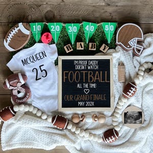 May include: A white onesie with the name "MCQUEEN" and the number "25" on it. A football-themed baby announcement with a letter board that reads "I'm proof daddy doesn't watch football all the time! Our grand finale May 202X".