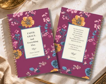 May include: Two spiral-bound prayer journals with a dark magenta background featuring a floral pattern of yellow and pink flowers. The left journal reads FAITH. GRACE. And Everything Else. The right journal contains a prayer and 1 Corinthians 16:14.
