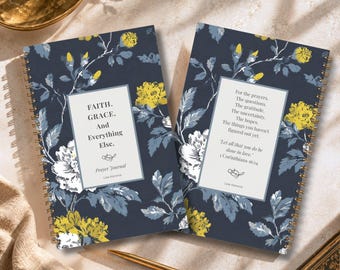 May include: Two spiral-bound prayer journals with a dark blue background featuring yellow and white floral patterns. The left cover reads FAITH. GRACE. And Everything Else. Prayer Journal. The right cover features a quote and 1 Corinthians 16:14.