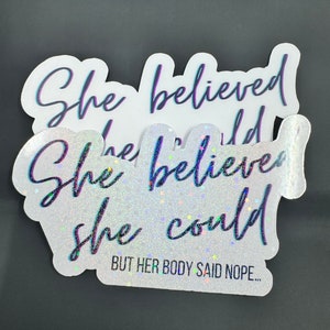 May include: A white sticker with glitter and a black cursive font that reads "She believed she could but her body said nope..."