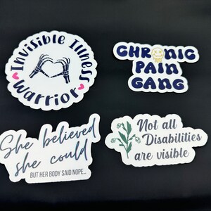 May include: Four white stickers with black and blue text and graphics. The first sticker says "Invisible Illness Warrior" with a skeleton hand making a heart shape. The second sticker says "Chronic Pain Gang" with a yellow smiley face. The third sticker says "She believed she could BUT HER BODY SAID NOPE..." The fourth sticker says "Not all Disabilities are visible" with a green plant graphic.