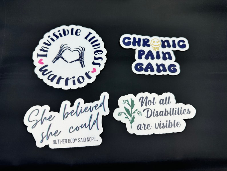 May include: Four white stickers with black and blue text and graphics. The first sticker says "Invisible Illness Warrior" with a skeleton hand making a heart shape. The second sticker says "Chronic Pain Gang" with a yellow smiley face. The third sticker says "She believed she could BUT HER BODY SAID NOPE..." The fourth sticker says "Not all Disabilities are visible" with a green plant graphic.