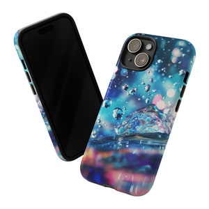 May include: A phone case with a blue and purple abstract design featuring water droplets and a large iridescent bubble. The case has a black border.
