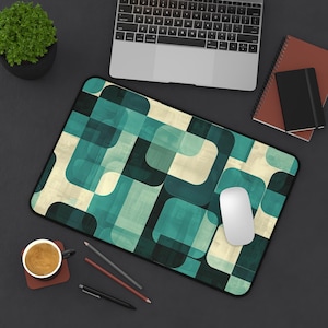 May include: A teal and beige geometric patterned mouse pad with a white computer mouse on top.