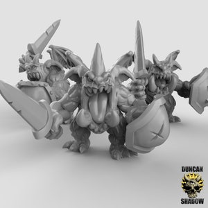 May include: A group of gray fantasy figurines, each depicting a monstrous creature with sharp teeth, horns, and wings. They are holding swords and shields. The Duncan Shadow logo is in the bottom right corner.