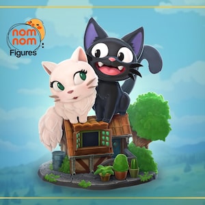 May include: A black and white cat figurine with a white cat figurine sitting on a small house with a green roof. The figurines are standing on a stone base with green plants.