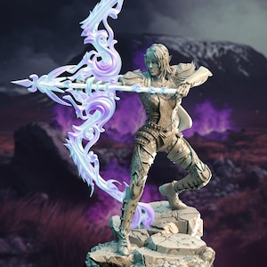 May include: A fantasy figurine of an elf archer with a flowing white and purple bow, standing on a rocky base. The elf is wearing detailed armour and is holding a bow and arrow.