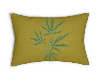 May include: Rectangular pillow with a textured, mustard-yellow background. A detailed illustration of a cannabis plant with green leaves and stems is centered on the pillow. The pillow is designed for decorative use.