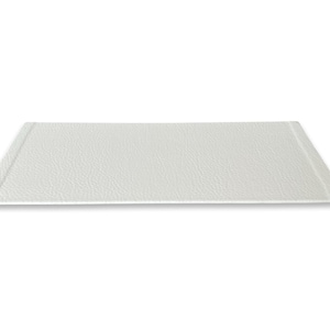 May include: A white rectangular tray with a textured surface. The tray has a slightly raised edge around the perimeter.